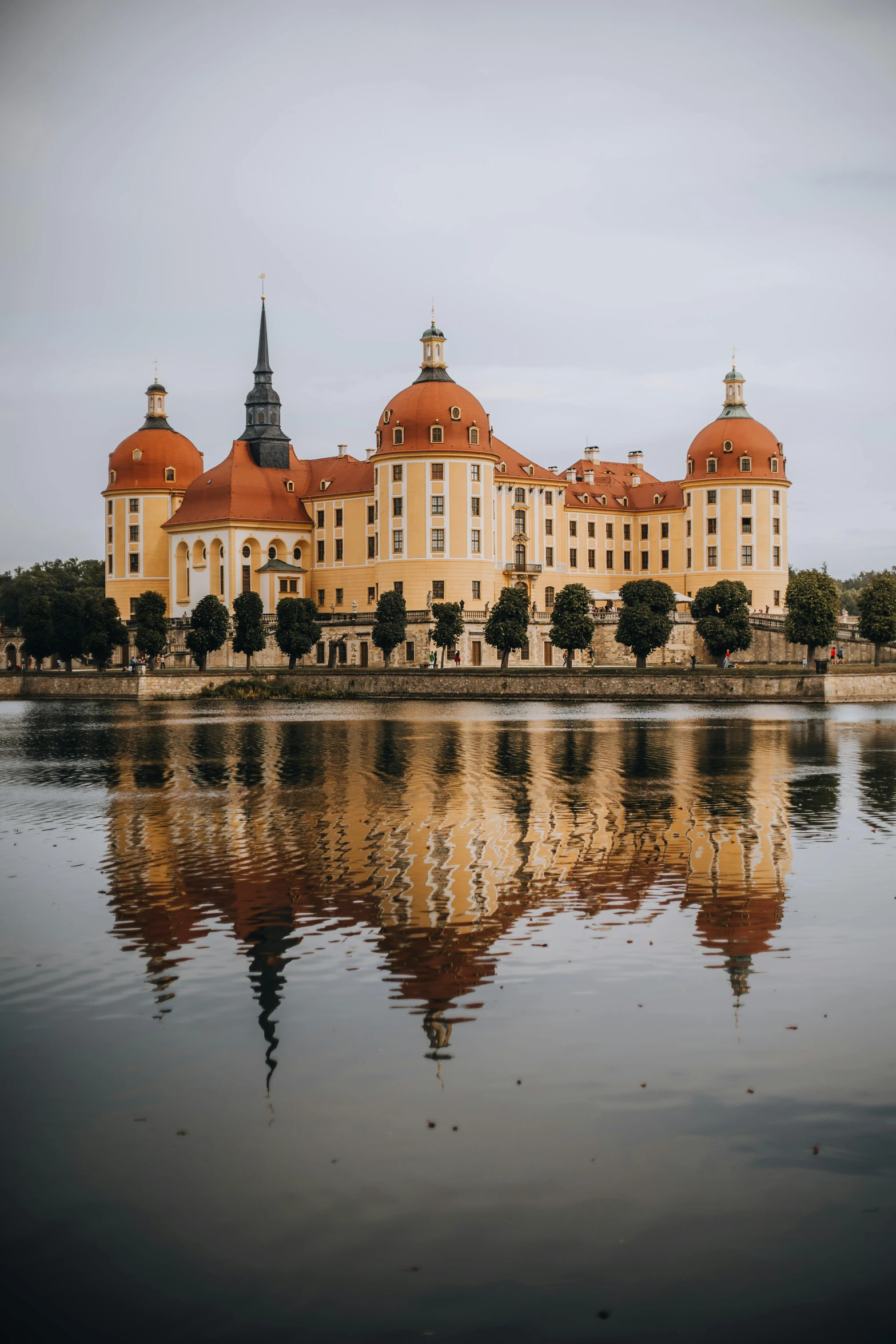 a large building is reflected in the water