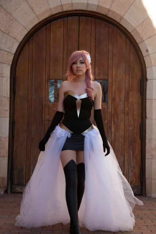 a woman in a black corset and pink wig, walking into a wooden doorway