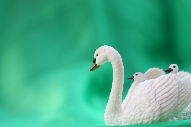 a group of white ducks in front of a green background