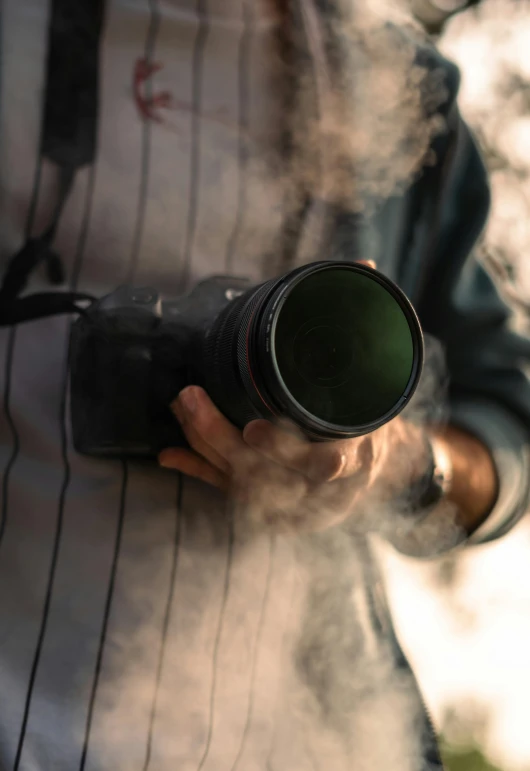 someone is holding a camera over their smoke