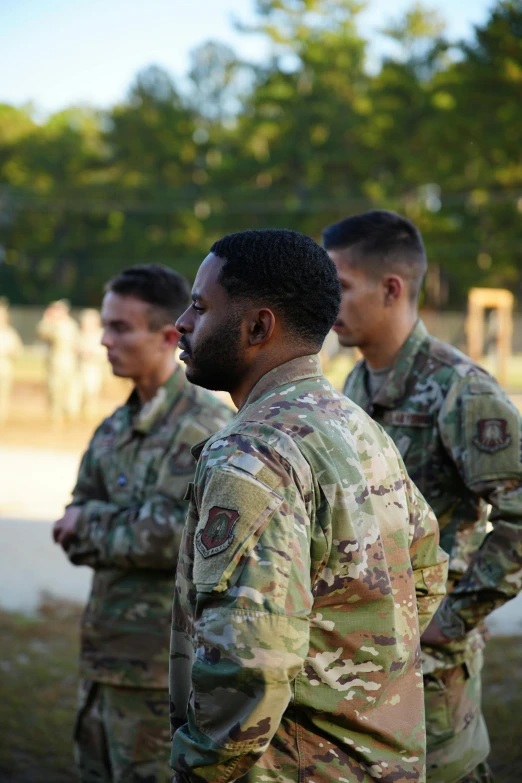 some men in uniforms are talking to each other