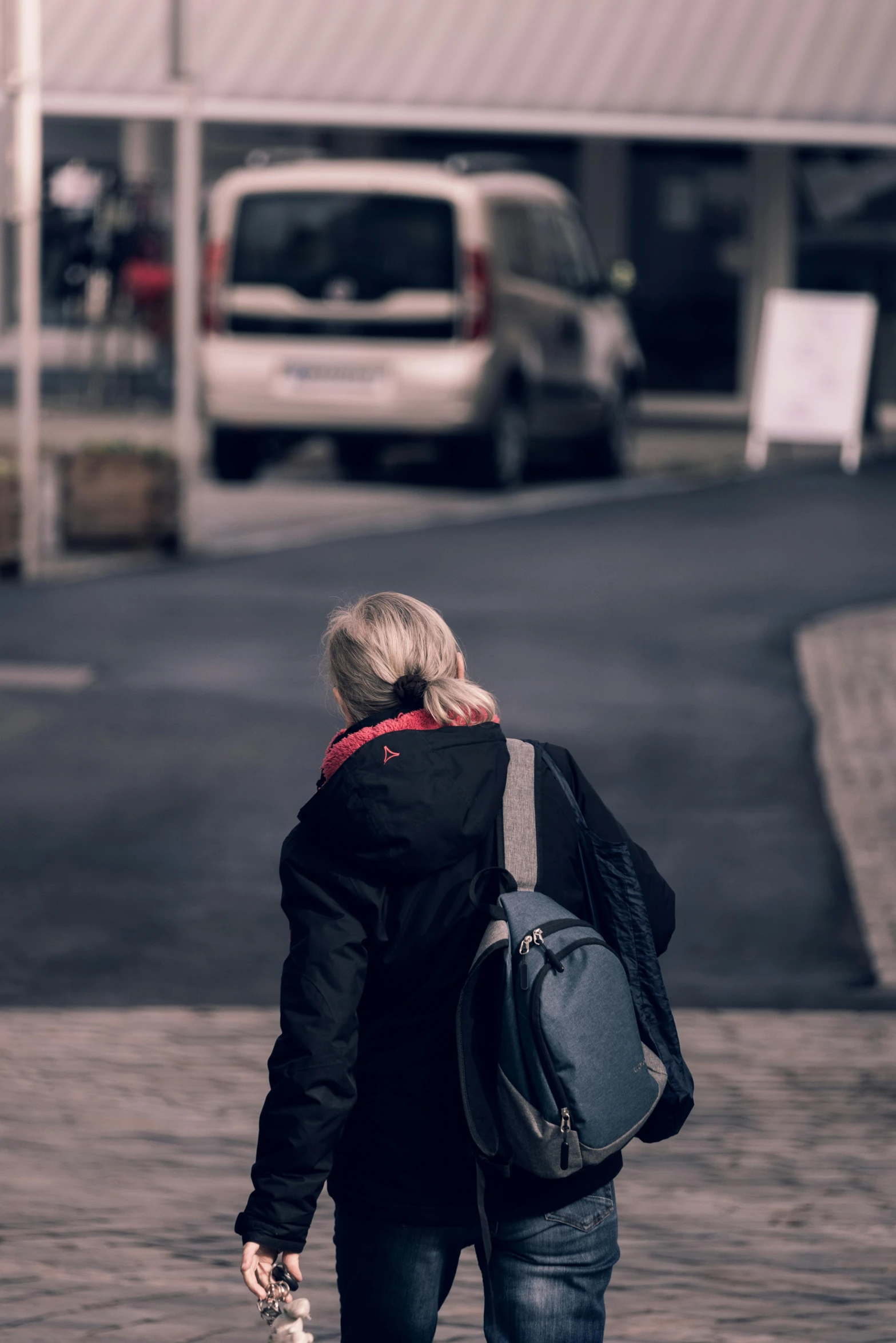 an old person walking down the street with his backpack