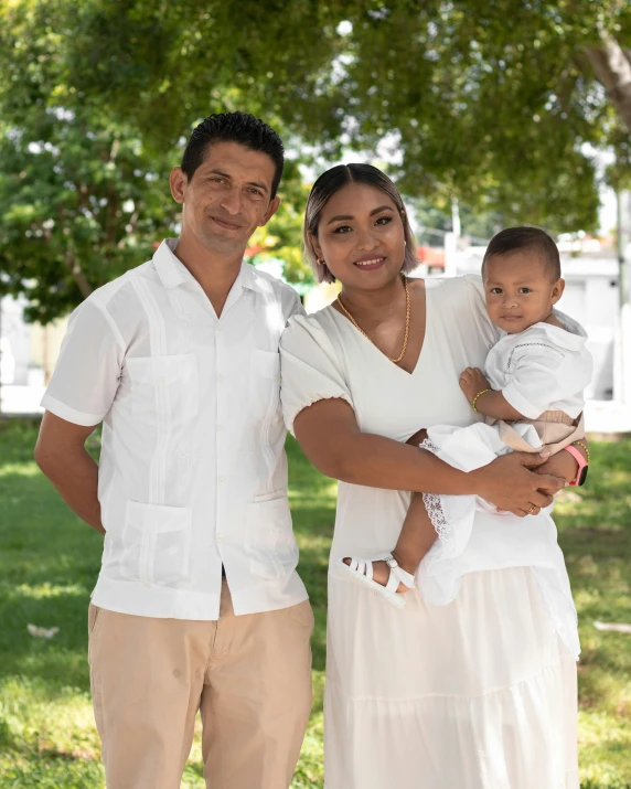 a family posing for a po in a park