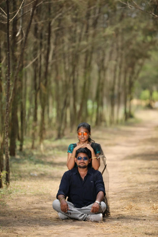 a man kneeling down while holding his young son on his shoulders