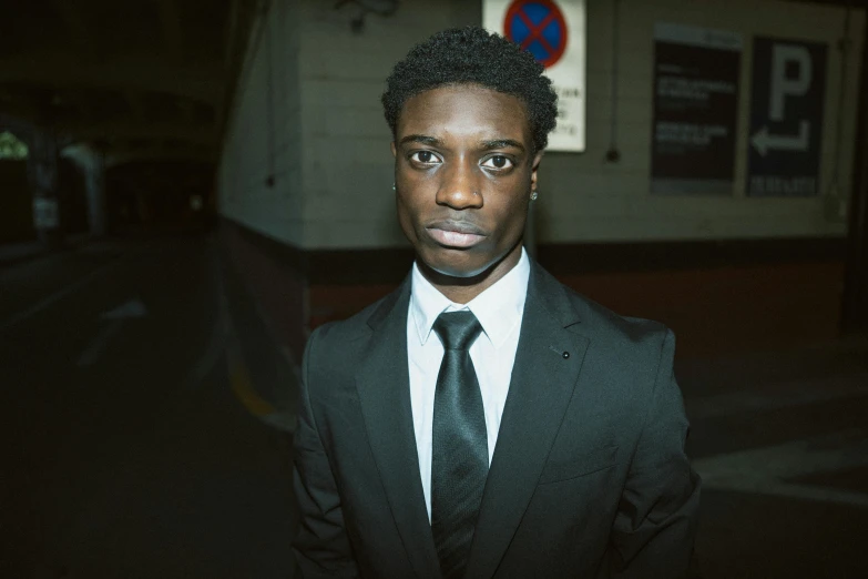 a close up of a person wearing a suit and tie