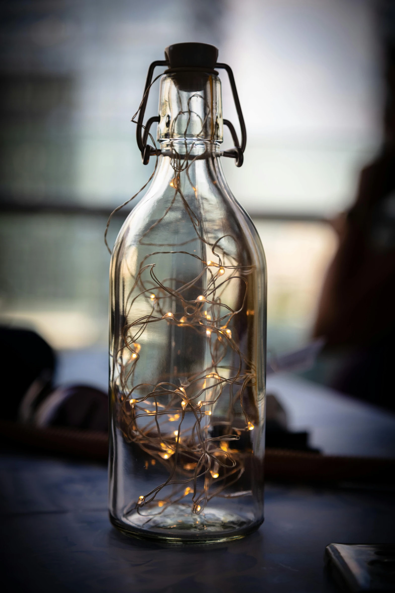 a glass bottle with string lights in it