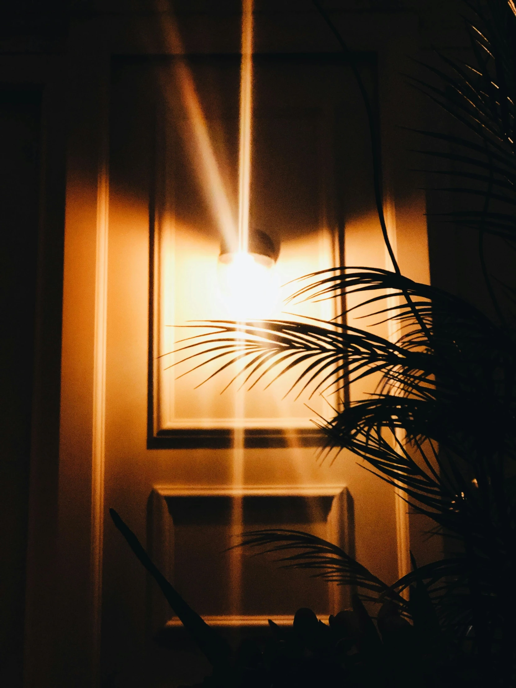 a window with the sun peeking through a window