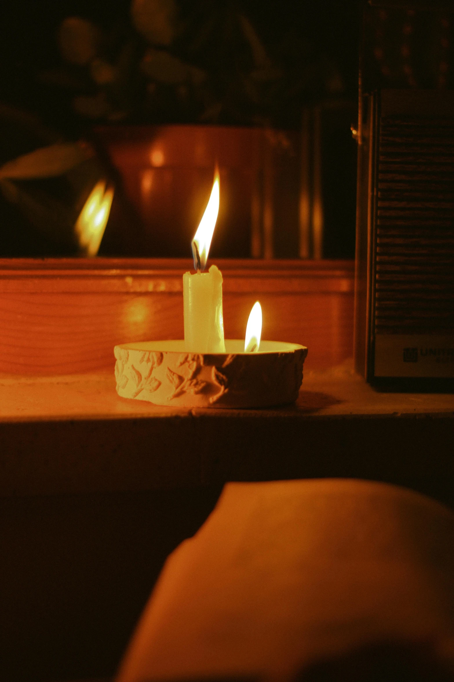 candles on a counter in a darkened room