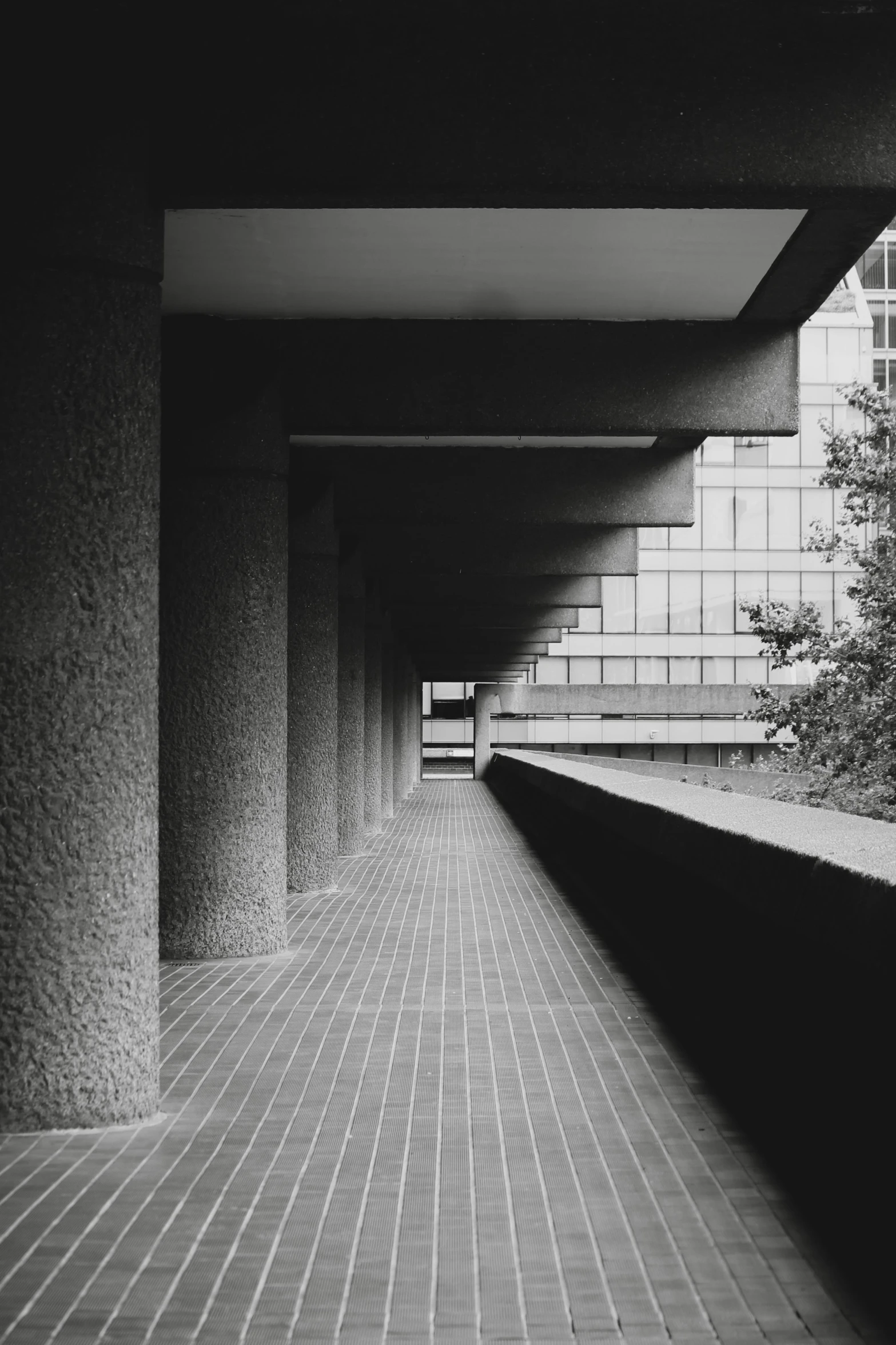 an empty walkway between two buildings in the middle of the day