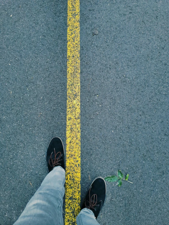 a person stands on the edge of a street