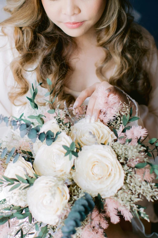 a girl is holding a bouquet of flowers