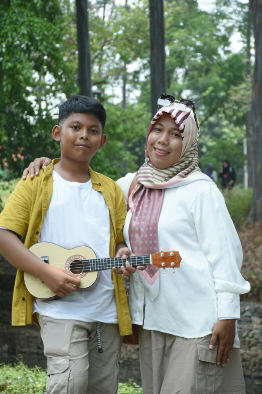 an asian woman and  with a ukele