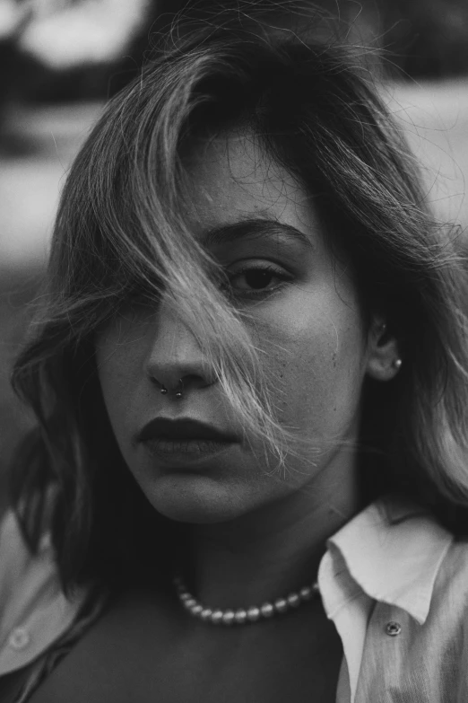 a close up of a person with long hair and a shirt