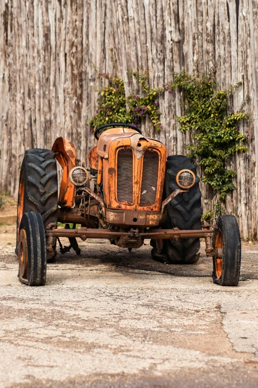 an old vintage farmall sits on a gravel surface
