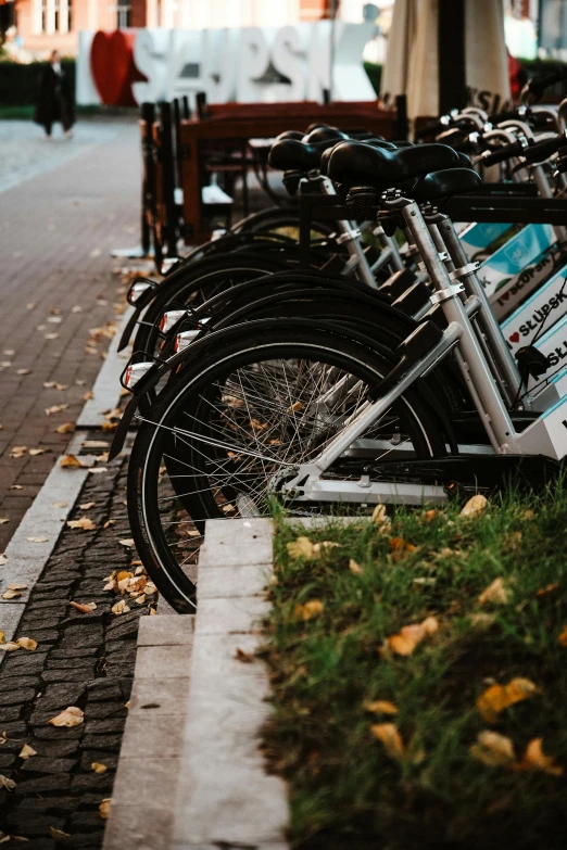 many bikes are parked next to each other