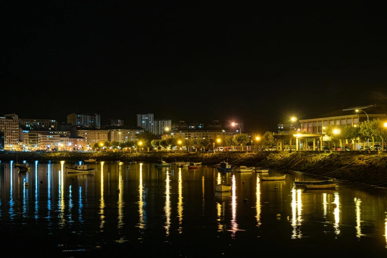 many lights reflected in the water near the river