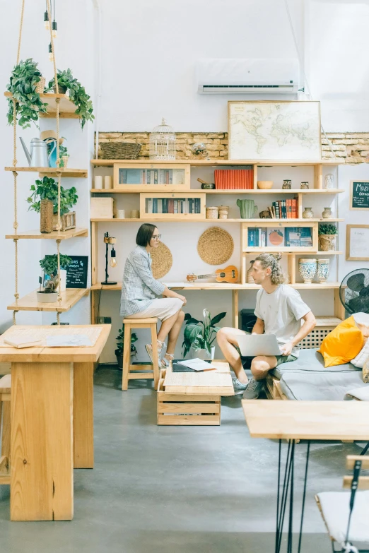 a couple sitting at a table in front of books