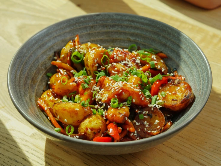 an asian food dish sits in a grey bowl