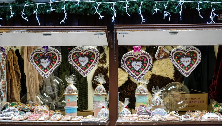 a store display window with large hanging hearts