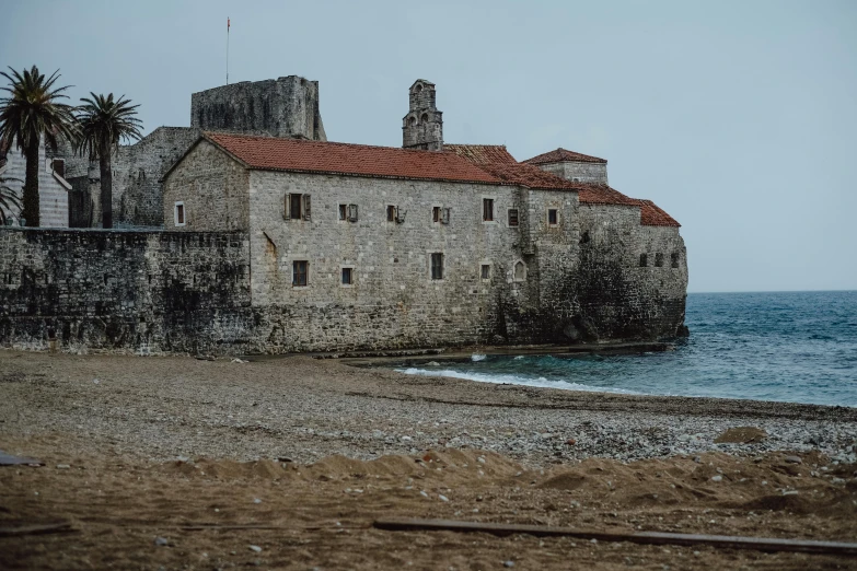 an old building sitting near the ocean