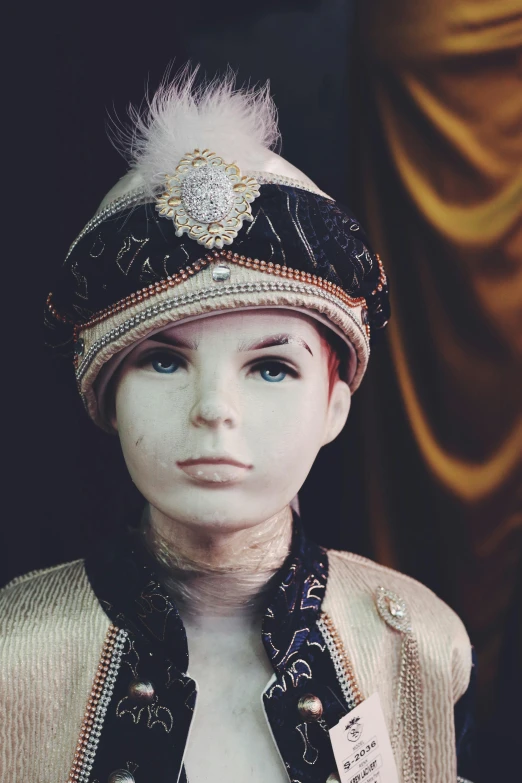 a mannequin wearing a turban with feathers