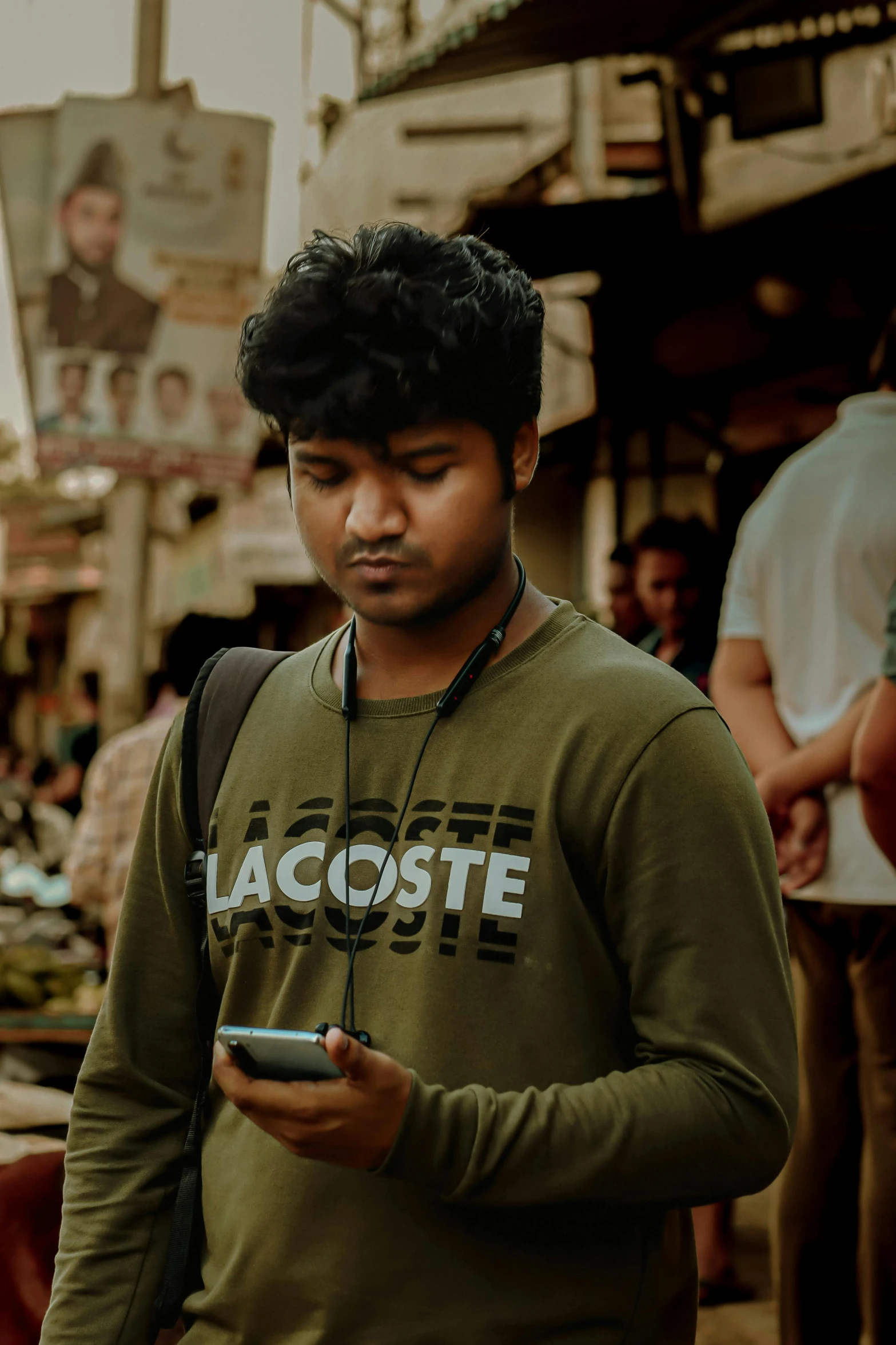 a man standing in the street while using a cell phone