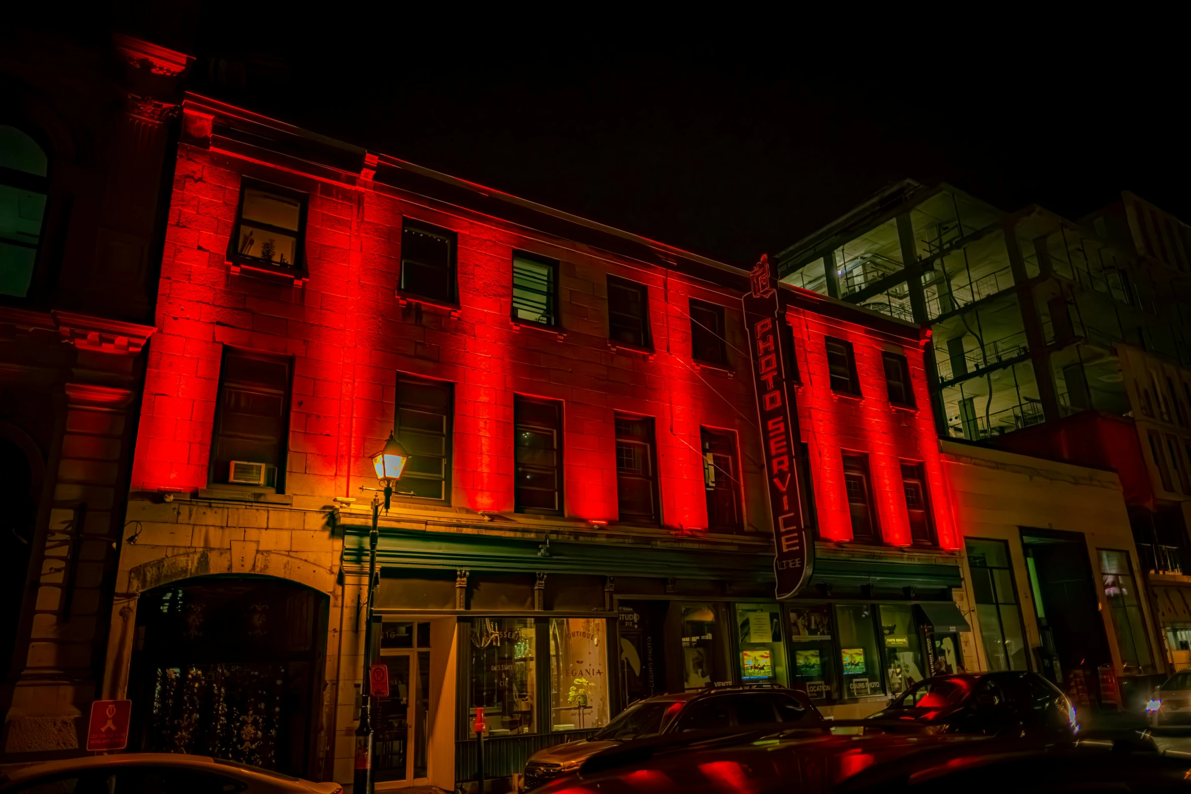 a large building that is lit red on the night