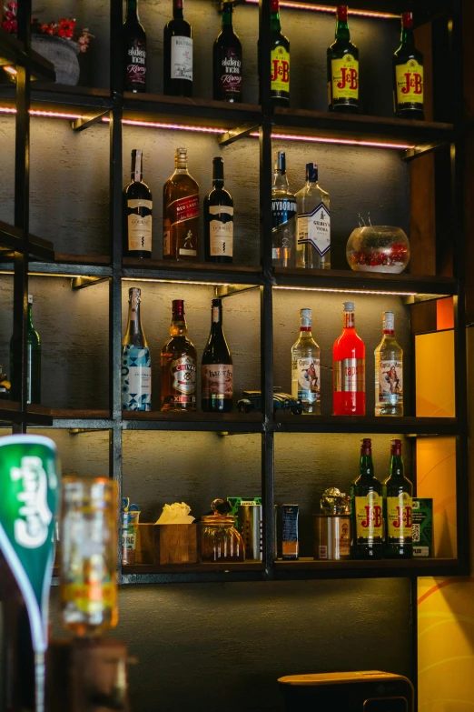 liquor bottles lined up on shelves in a bar