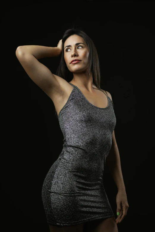 a beautiful woman standing next to a black background