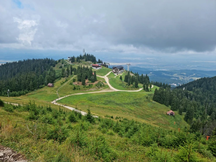 a scenic view of a valley with rolling mountains