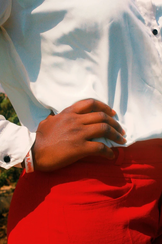 a person with red pants and white shirt