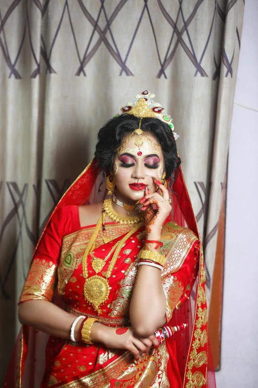 woman in traditional indian costume talking on the phone