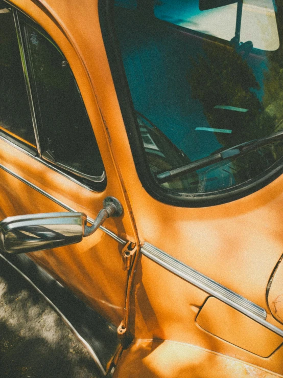 the interior of an orange car in the sun