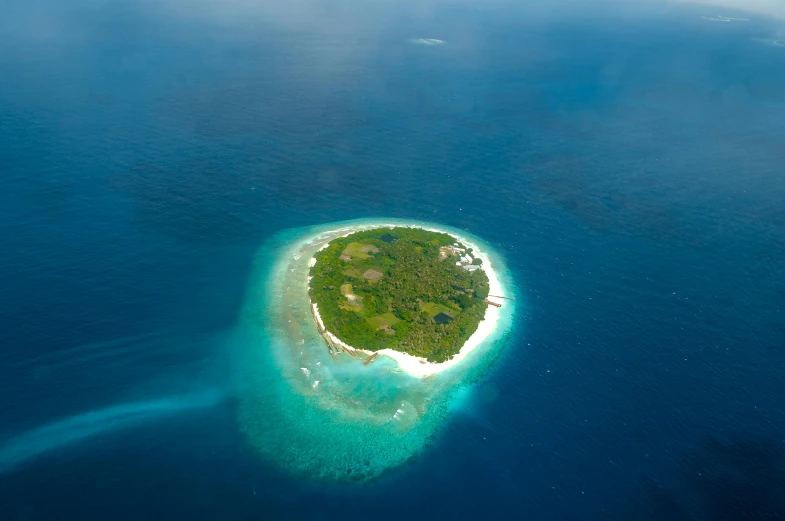 a small island is surrounded by blue water