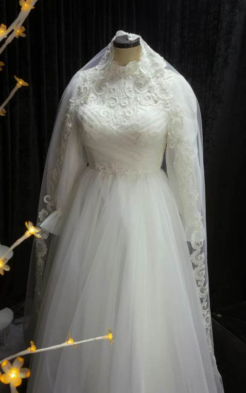 a white dress on display with flowers in it