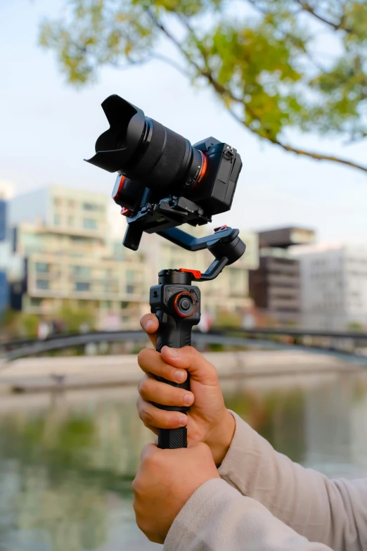 a man holding a camera up to take a picture