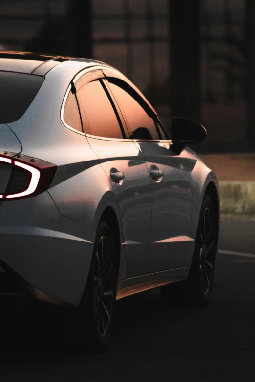 the side view of a grey sedan with an on camera flash