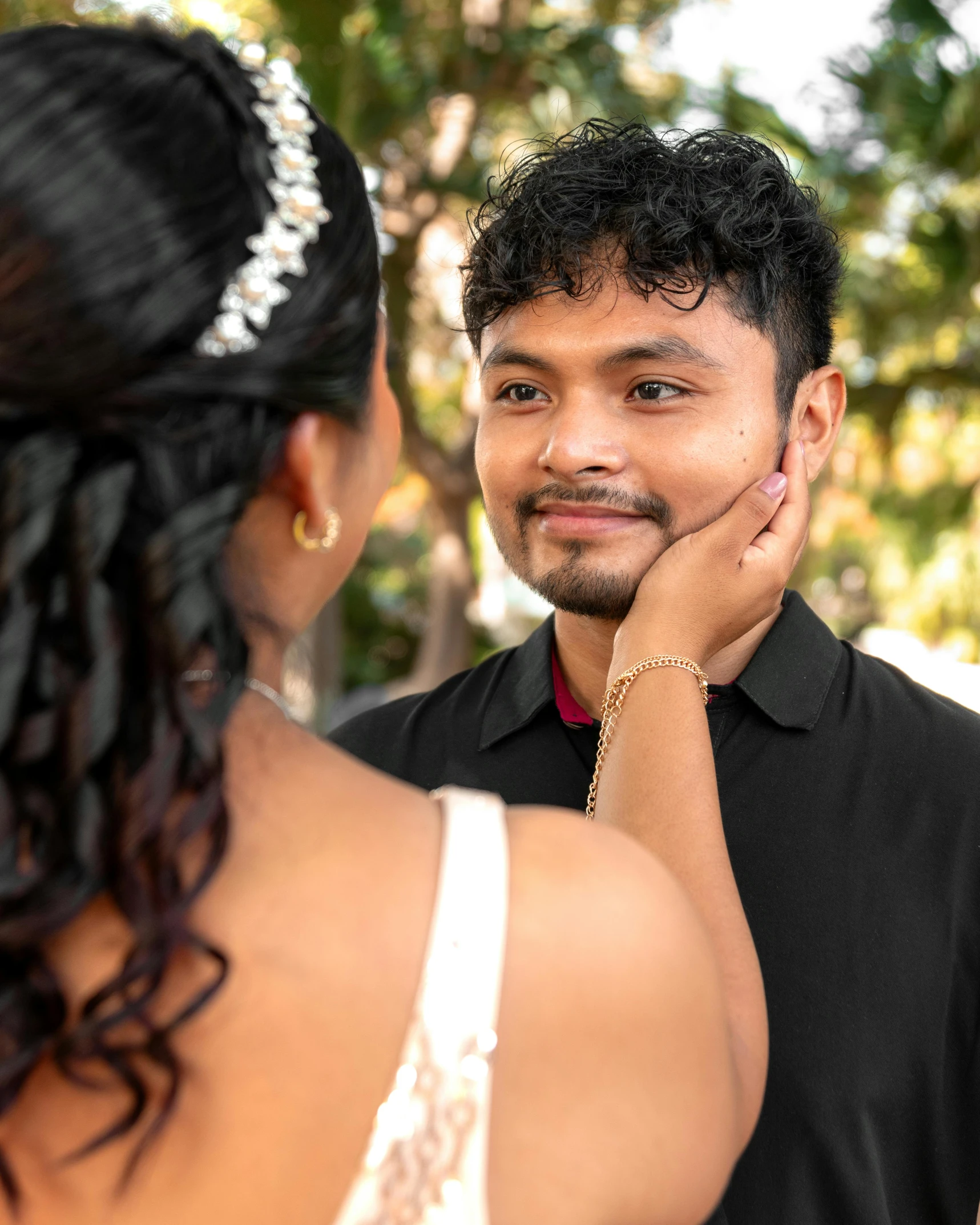 a beautiful young lady standing next to a man