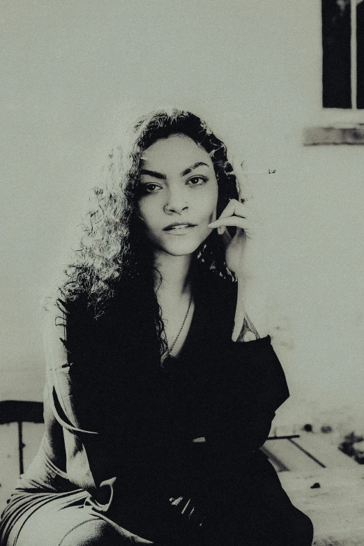 a young woman is sitting in front of a mirror