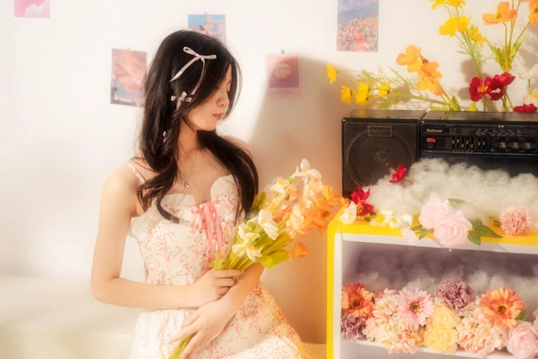 a woman wearing a white dress stands with a bouquet in her hand