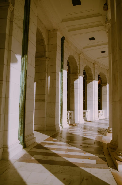 a hallway with columns and arches in a building