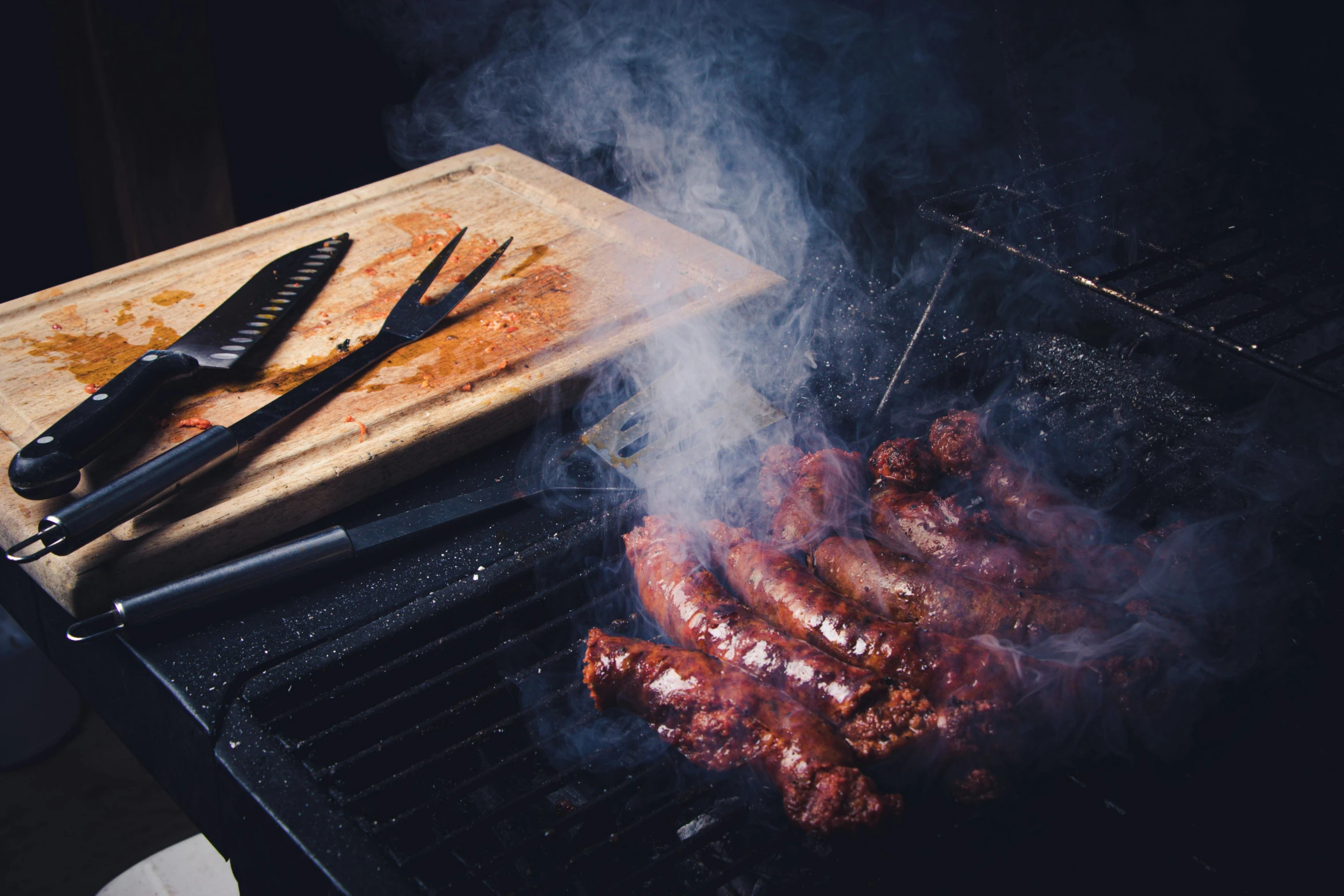 cooking on an electric grill with tongs and tongs