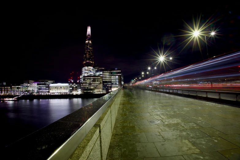 a cityscape showing a night view of skyscrs and the london eye