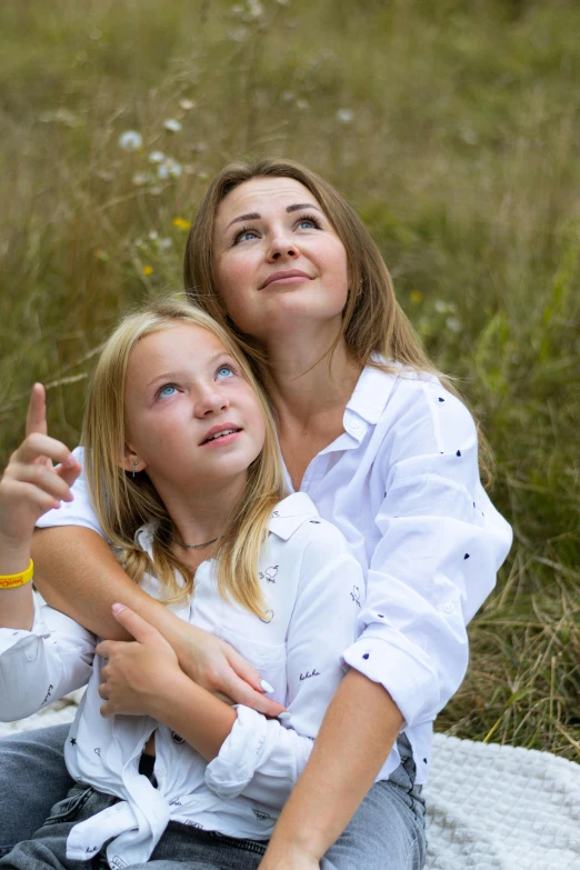 two beautiful young women posing for a po