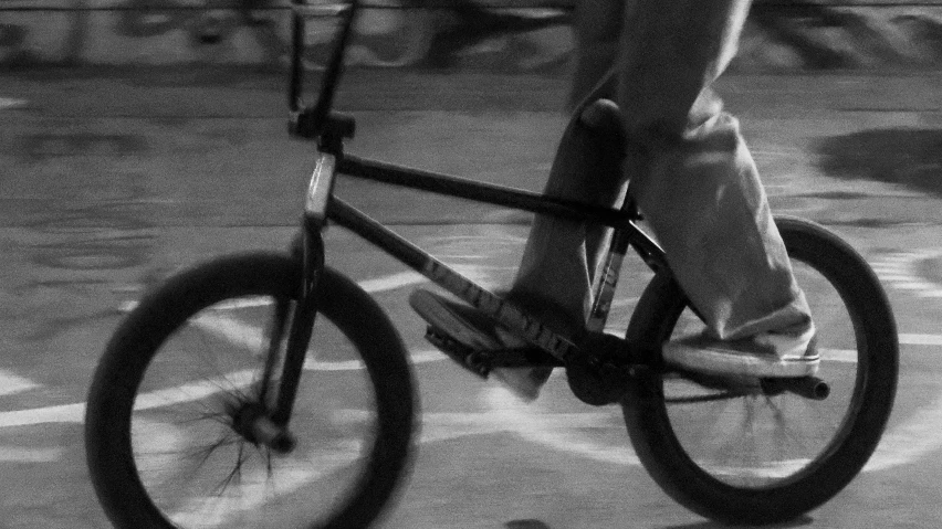 black and white po of man riding bicycle