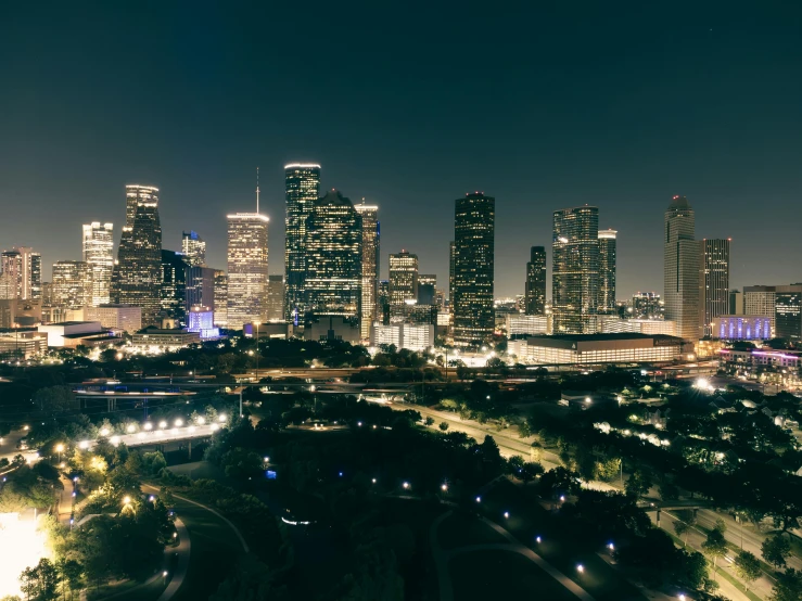 a view of the city at night from a top of a hill