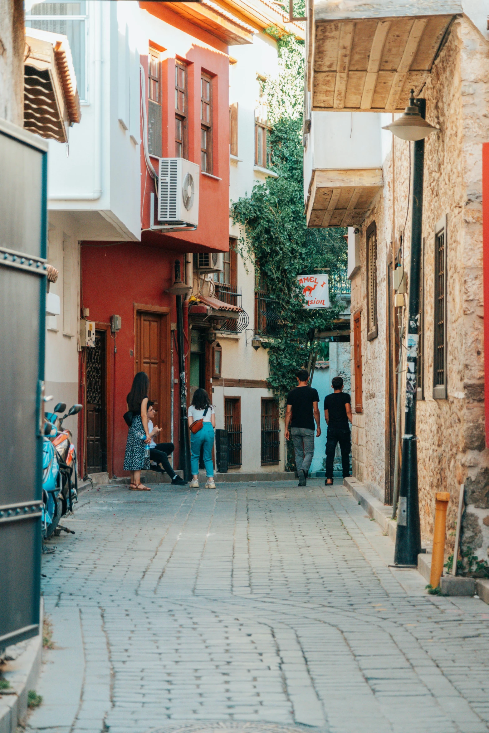 some people sitting on chairs and walking down a street