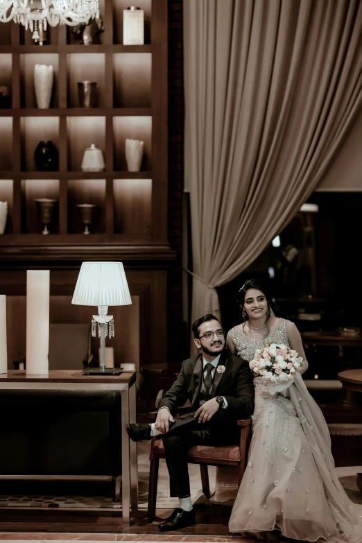 a young bride and groom sit together at the table