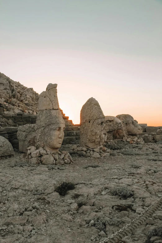 the sun is setting on the rocks and stones