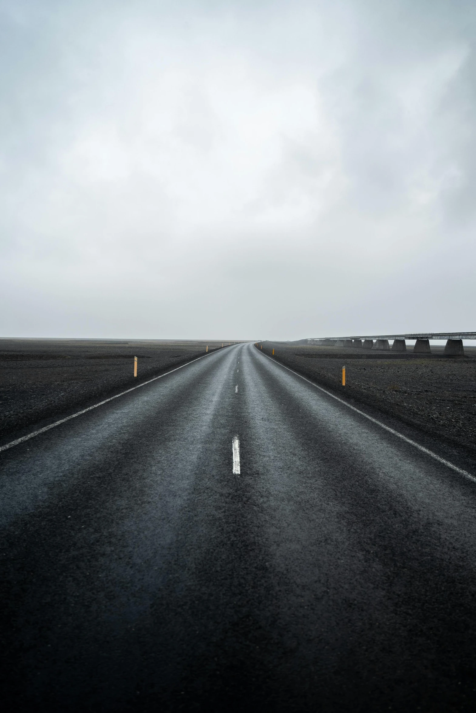 the empty road is going through nowhere on a gloomy day